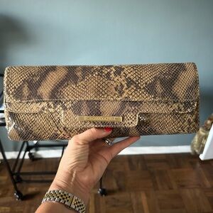Faux snake skin BCBG MaxAzria magnetic closure clutch.